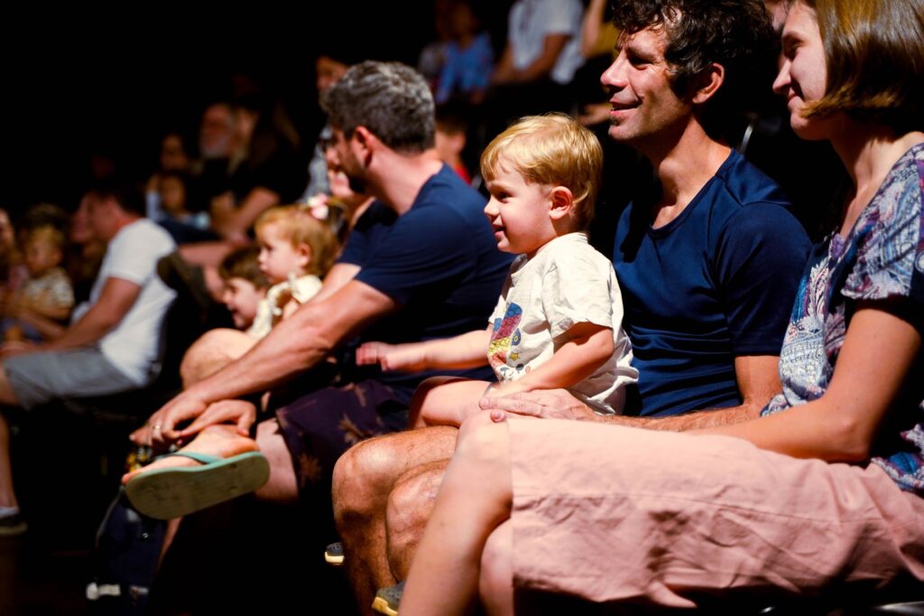 family enjoying a theater show in brasil